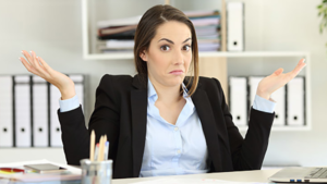 Woman shrugging to show she's less informed.