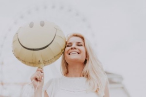 Jovial July woman with smiley baloon