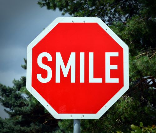 Incredibly Easy Things to Stop Doing to Be Happier - Smile stop sign